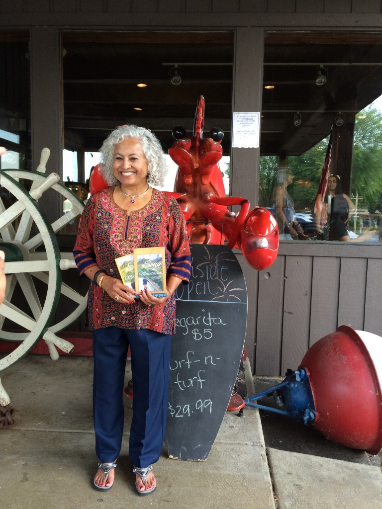 Author Shakuntala Rajagopal with her book Song of the Mountains at Port Edward book signing